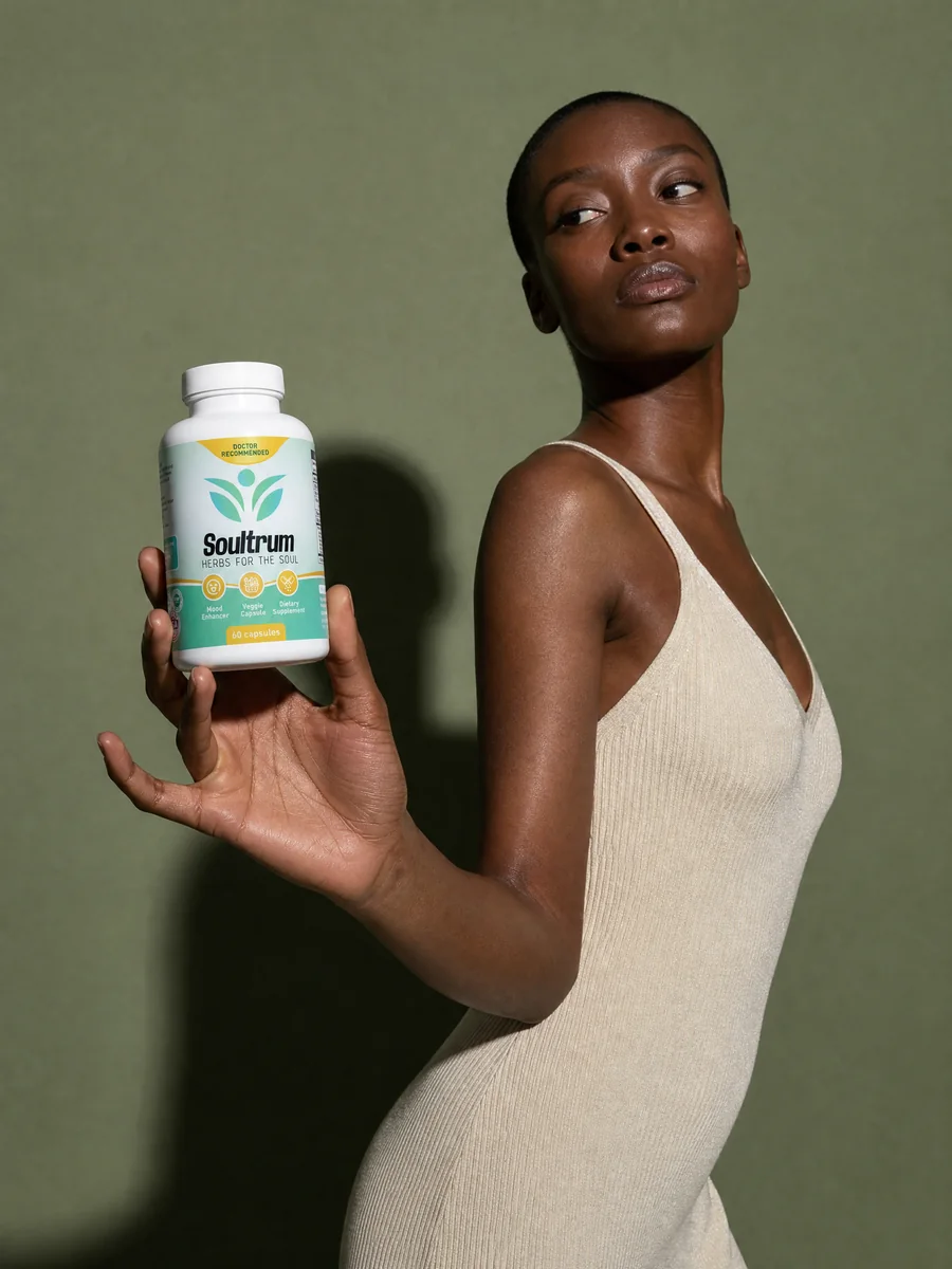 Editorial campaign image of a model holding the Soultrum bottle